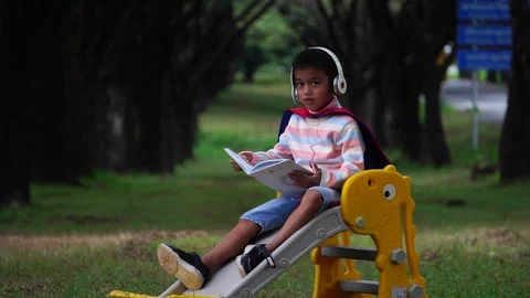 Childen sitting in the park studying Stock Footage 221698531