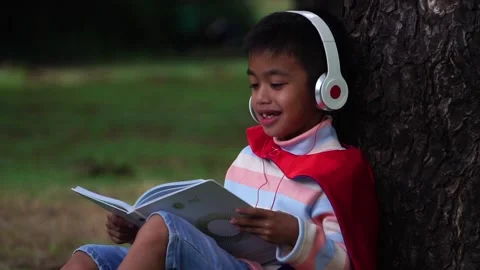 Childen sitting in the park studying Stock Footage 221698542