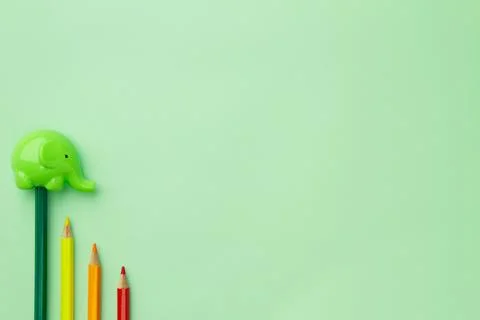 Childish pencil sharpener in the form of an elephant and four pencils stairs  Stock Photos