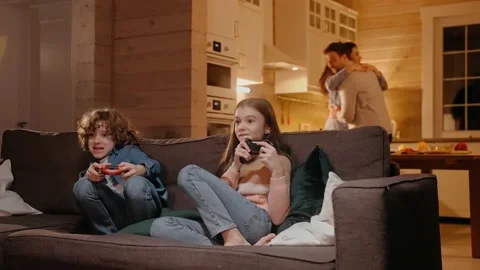 Children actively playing on game console, parents are dancing at the background Vídeo Stock 165412250