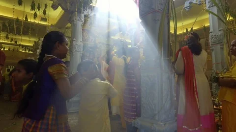 Children amazed with the light diffuse through roof top at a temple. Stock Footage 89106563