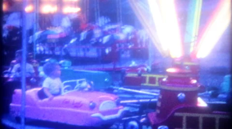 Children at amusement park, neon at twilight 1950s vintage film home movie 3341 Stock Footage