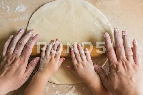 Children and dad hands rolled dough Stock Photos