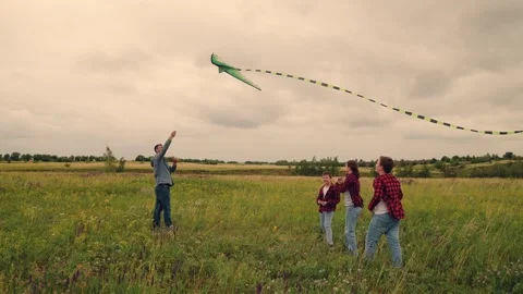 Children and father sharing fun, launching dreams skyward, playful laughter Stock Footage 313205890