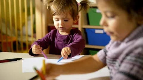 Children and fun, two happy preschoolers drawing in kindergarten Stock Footage 12224450