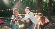 Children And Recreation. Group Of Happy Multiethnic School Kids Playing Tug-Of Stock Footage
