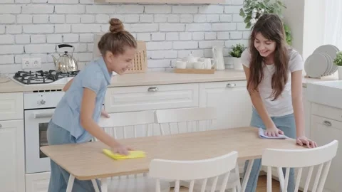 Children are happy to put things in order and clean the kitchen. Little sister Stock Footage 140455782