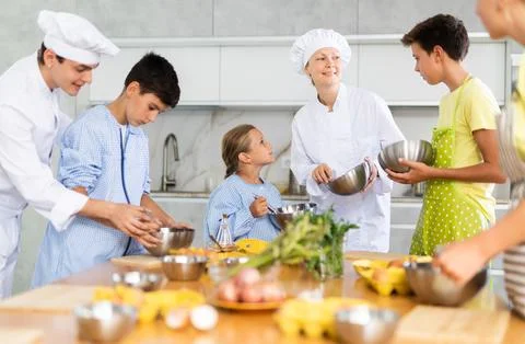Children are interested in learning in culinary courses under the supervision of Stock Photos