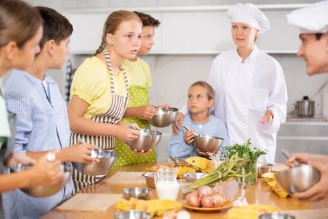 Children are interested in learning in culinary courses under the supervision of Stock Photos