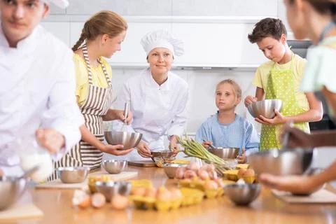 Children are interested in learning in culinary courses under the supervision of Stock Photos