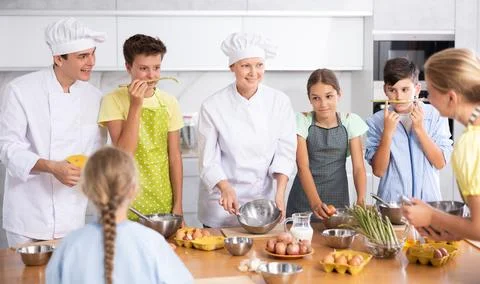 Children are interested in learning in culinary courses under the supervision of Stock Photos