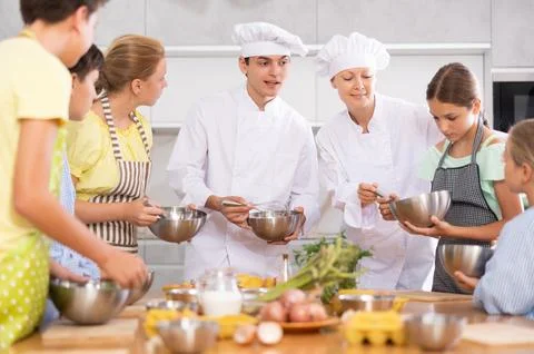 Children are interested in learning in culinary courses under the supervision of Stock Photos