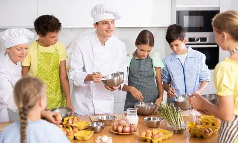 Children are interested in learning in culinary courses under the supervision of Stock Photos