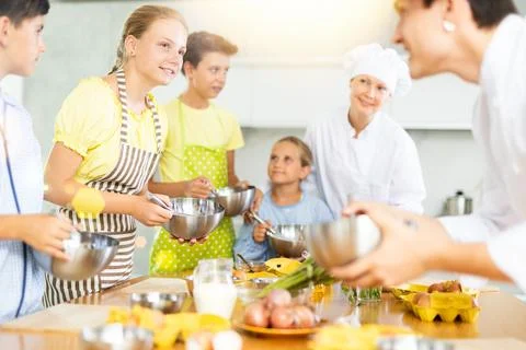 Children are interested in learning in culinary courses under the supervision of Stock Photos