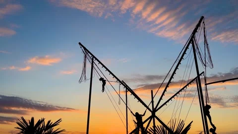 Children are jumping on bungee trampoline against sunset sky - slow motion Stock Footage 336929065
