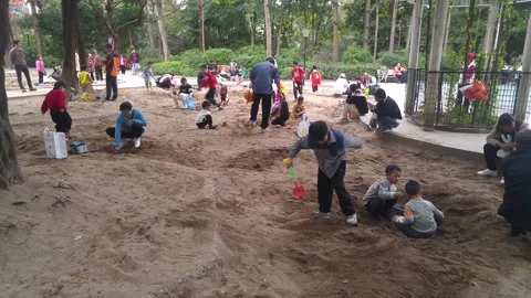 The children are playing and digging sand pits Stock Footage 301097767