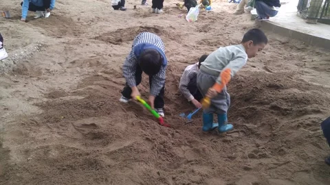 The children are playing and digging sand pits Stock Footage 301098737