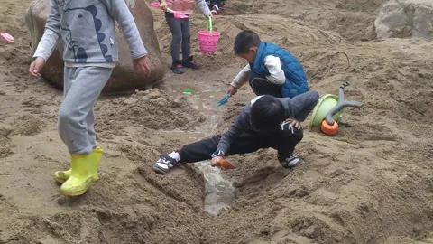 The children are playing and digging sand pits Stock Footage 301178839