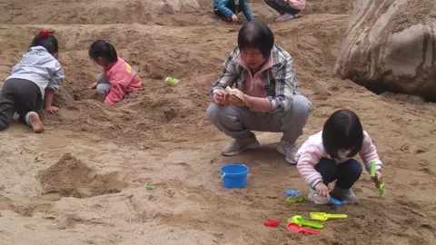 The children are playing and digging sand pits Stock Footage 301179934