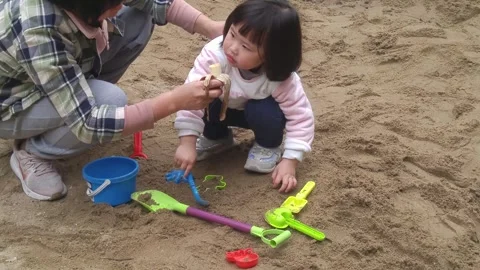 The children are playing and digging sand pits Stock Footage 301180997