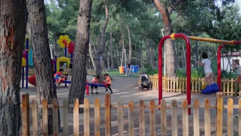 Children are playing and having fun on playground in the park Stock Footage 201216051