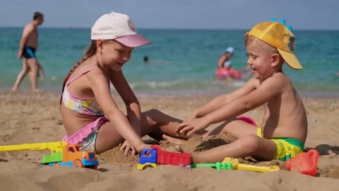 Children are playing on the beach. Summer water fun for the whole family. Stock Footage 160309977