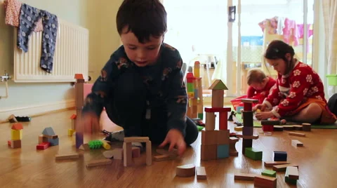 Children are playing with building blocks in the family home Stock Footage 60099528