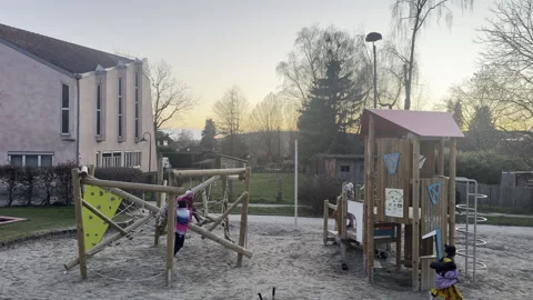 Children are playing on a playground Stockbeeldmateriaal 333527064