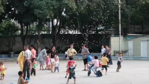Children are playing in the square under the care of their parents Stock Footage 152957133