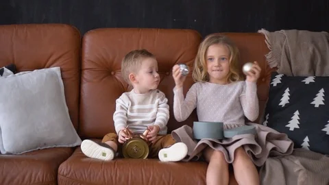 Children are sitting on a sofa and playing with christmas toys. Stock Footage 120541311