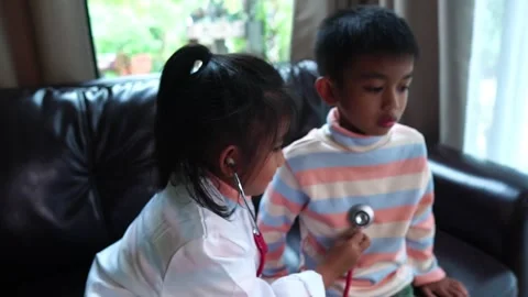 The children are taking on the role of doctors treating the sick. Stock Footage 221698461
