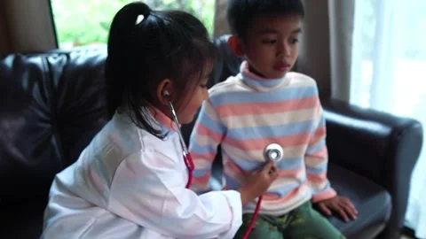 The children are taking on the role of doctors treating the sick. Stock Footage 221698466