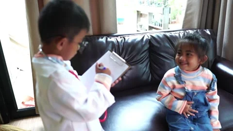 The children are taking on the role of doctors treating the sick. Stock Footage 221698712