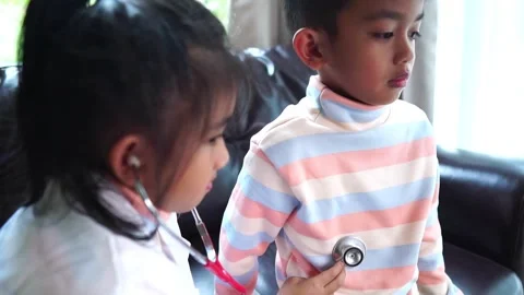 The children are taking on the role of doctors treating the sick. Stock Footage 221702237