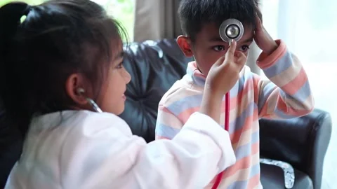 The children are taking on the role of doctors treating the sick. Stock Footage 221702317