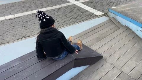 Children are very creative. A slide turned out from an ordinary bench. Stock Footage 238556931
