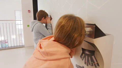 Children are watching microscopes in the modern science and educational centre Stock Footage 236359550