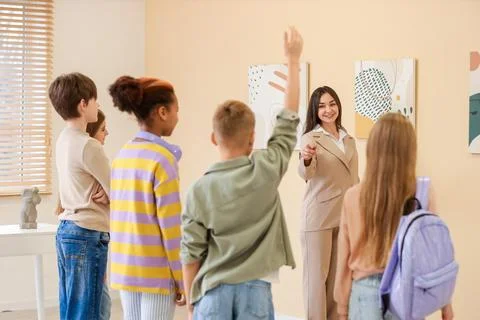 Children asking question to guide at exhibition in modern art gallery Stock Photos
