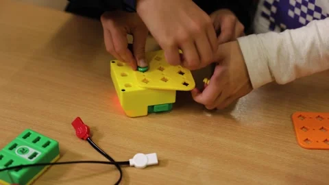 Children assembling colorful electronic components during hands on STEM robotics Stock Footage 341895868