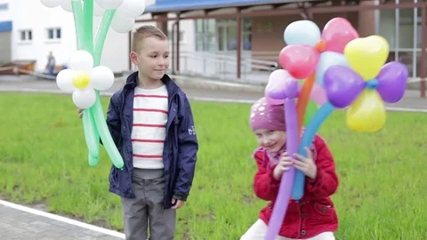 Children with balloons in the form of flowers. Stock Footage 70978717