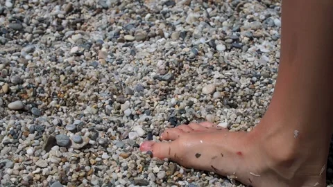 A children bare feet on a pebble beach Stock-Footage 281780348