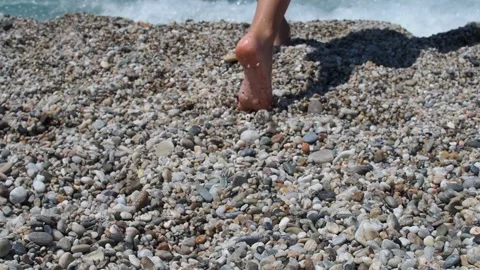 A children bare feet on a pebble beach Stock Footage 281795155