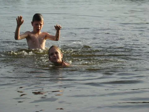 Children bathing in the river Stock Photos