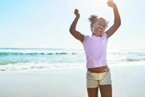 Children, beach and fun with a black girl dancing alone on the sand in summer by Stock Photos