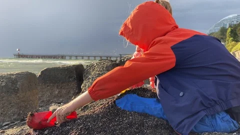 Children on the beach playing with sand Stock Footage 117482772