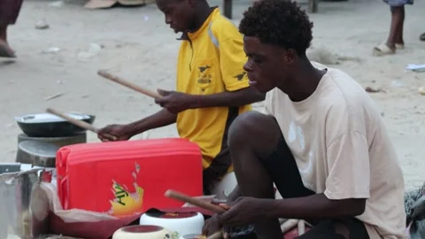 Children beating drums on the side of the road. Stock Footage 291413730
