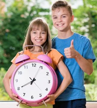 Children with big clock Stock Photos