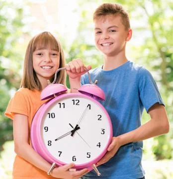 Children with big clock Stock Photos