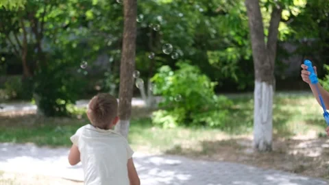 A children blows soap bubbles. Stock Footage 277540735