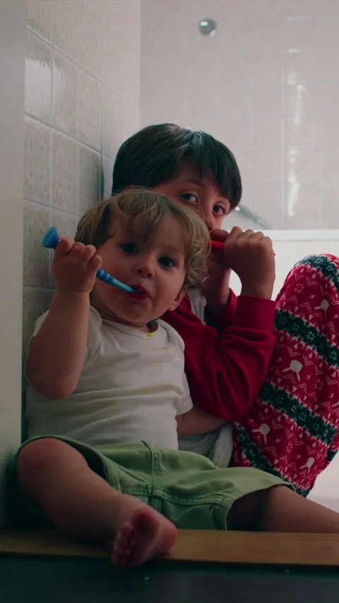 Children brushing teeth together before bedtime in family bathroom, highlig.. Stock Footage 337410965